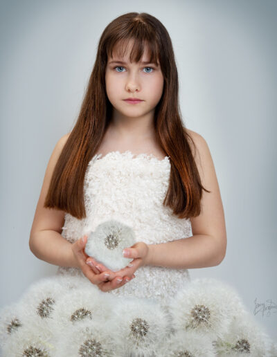 Girl with dundelions in seed